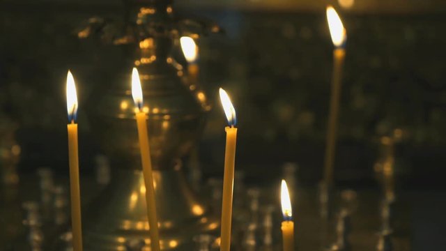 Religious traditions. Candlestick with burning candles in the temple. Close up