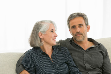 middle aged couple on a sofa: in love concept