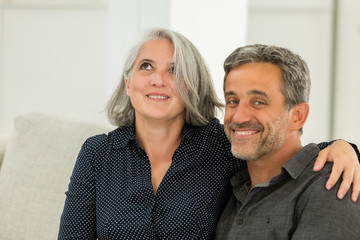 middle aged couple on a sofa: in love concept