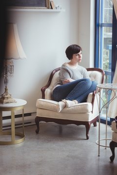 Woman sitting in armchair at home