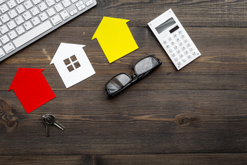 buy house online with paper figures and keys on office desk wooden background top view mock-up
