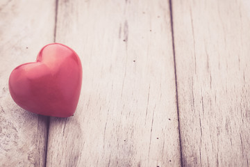 Red heart on the gray metal background.