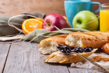French baguette with butter and jam for breakfast
