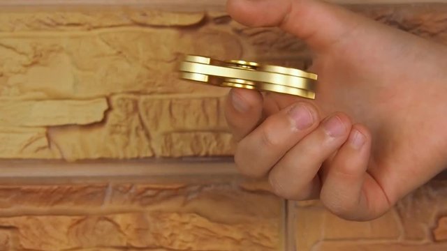 A spinning spiner on a child's hand. The hand of a child with a spinner close up.