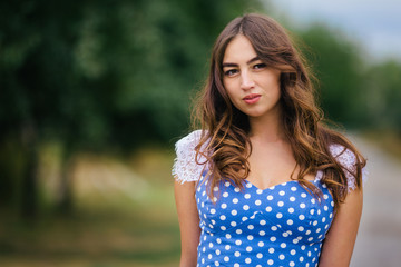 Fototapeta premium Portrait of young attractive woman in retro style dress. Romantic beauty and fashion