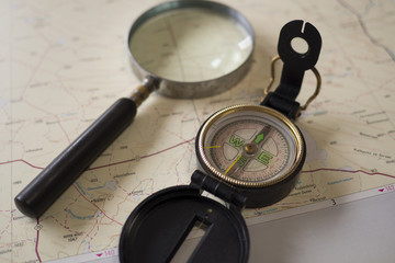 Compass and magnifying glass on a map