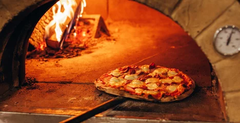 Rolgordijnen Italian pizza is cooked in a wood-fired oven. © andrew_shots