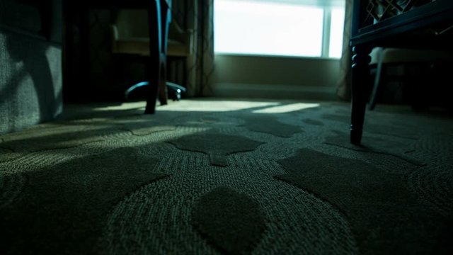 Hotel Room Low Angle Shades Open Move Left Blue Tint. low angle of hotel room floor as automatic shades and blinds open to reveal morning as view moves left
