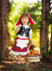 Little Red Riding Hood in the forest carries pies in the basket