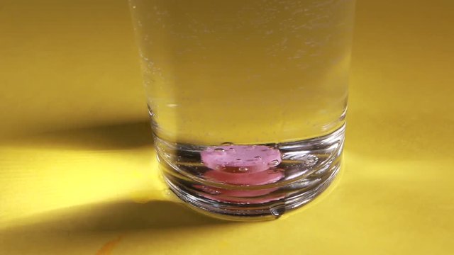Pills inside a glass of water
