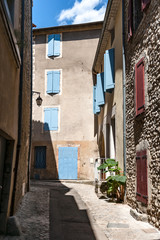 Authentic French town with narrow streets, colorful houses and atmospheric flowers.