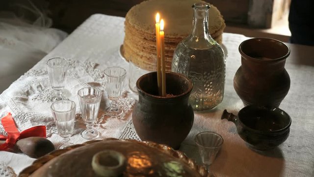 Wedding ceremony. Witchcraft. Burning candles inserted into the clay pot with the rice