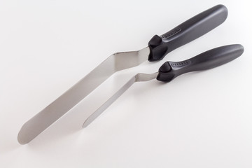 Spatula or Cake scraper for scraping fondant or icing on cake pastry of pie isolated on white background