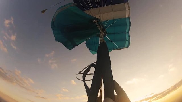 Skydiver untangle parachute in sky. Height. Extreme situation. Sunset. Speed. Adrenaline.