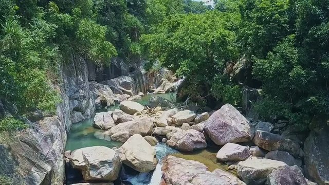 Camera Flies over Mountain River with Rapids Cascades