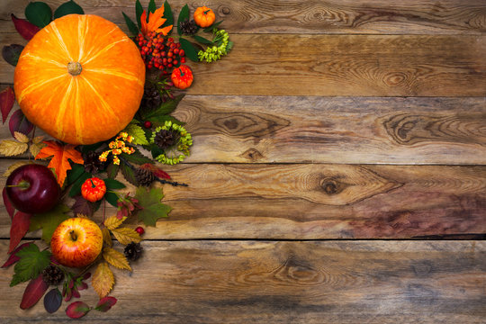 Happy Thanksgiving decor with fall leaves on wooden background