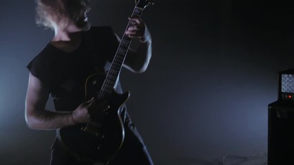 Concert rock band performing on stage with guitarist. man plays the electric guitar. Music video punk, heavy metal or rock group.