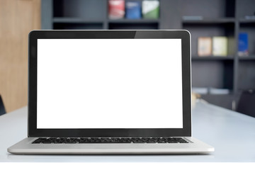 Fototapeta premium Mock up Blank screen of Laptop on marble table in Co-working or cafe.