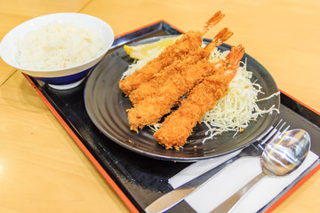 Japanese deep fried shrimp or tonkatsu set with rice on wooden table