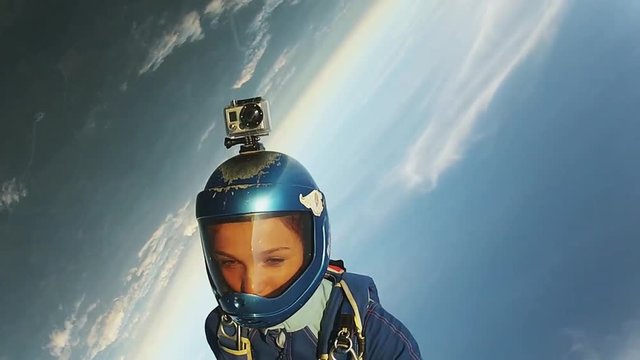 Two professional skydivers jump from airplane fall in sky together. Uniform. Extreme stunt