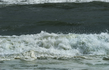 Closeup of crashing waves and breakers during tropical storm