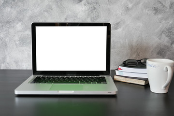 Fototapeta premium Laptop with white screen monitor on the desk.