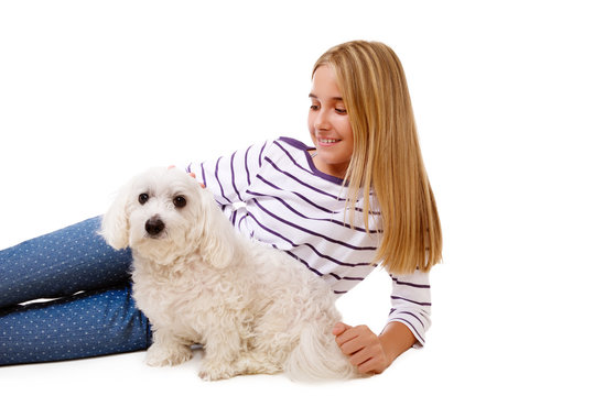 happy lovely girl laying on the floor with maltese dog,isolated