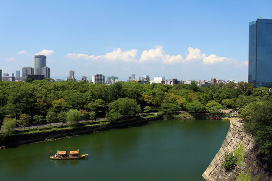 A view of a boat and the skyline of Osaka city