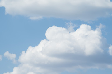 Naklejka na ściany i meble White fluffy clouds on a blue sky, wallpaper