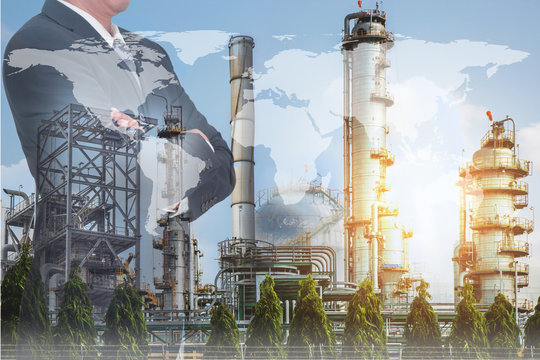 Double exposure of Businessman arms crossed and stand up, world map, Electric Generating, fuel oil Factory and Energy Industry plant as business, industrial and energy concept.