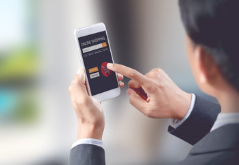 Businessman shop online on mobile with shopping cart, digital technology concept