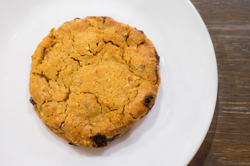 Chocolate chip cookies on white plate in cafe
