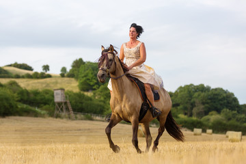 mature woman riding an Andalusian horse