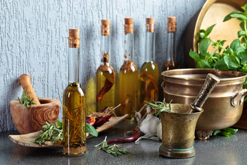 Vintage kitchen utensils with bottles of olive oil.