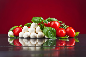 Mozzarella with tomatoes and green  basil.