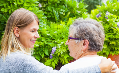 Senior lady with caregiver back view