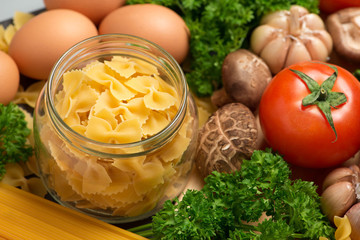 Italian food concept. Pasta ingredients. Cherry-tomatoes, spaghetti pasta, rosemary and spices