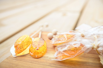 Honey caramel candy lollipop on wooden background