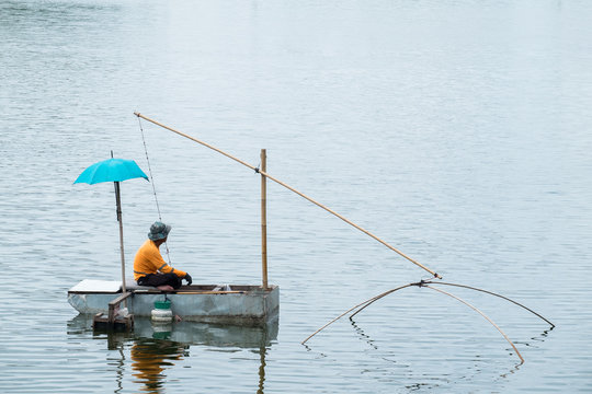 Asian fisherman fishing in the river morning.