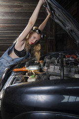 Fototapeta na wymiar mechanic girl repairs