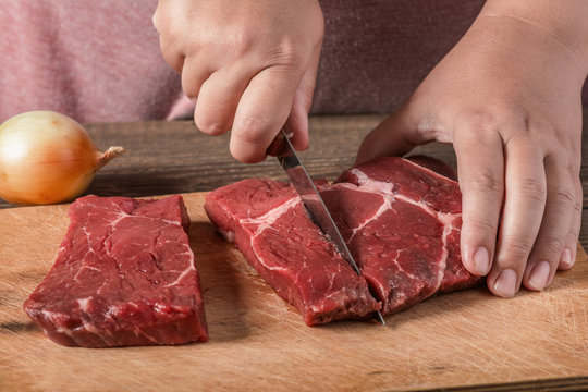 Cutting meat on a board