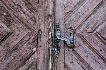 Old Door Handle. Old rusty gate handle on wooden door.