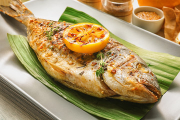 Plate with delicious fried fish, closeup