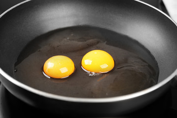 Cooking of delicious sunny side up eggs, closeup