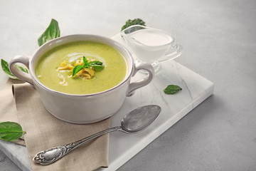 Broccoli cheddar soup in casserole and sauce on board