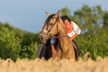 portrait of a woman on an Andalusian horse