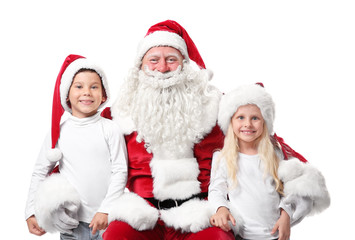 Cute kids in Christmas hats and authentic Santa Claus on white background