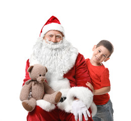 Obraz premium Cute boy and authentic Santa with teddy bear against white background