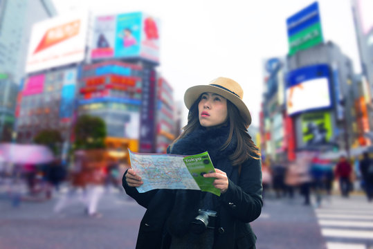 Asian woman tourist is traveling at Shibuya junction and hand on map with feeling worry emotion.