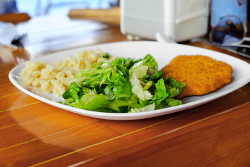 Plate with tasty dinner on table